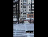 2 girls throw snow for photo 