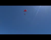 Collab risksIG - man white helmet sky dive red parachute