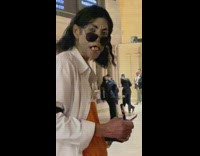 Michael Jackson impersonator stands in train station 