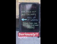 Black sign offers toilet paper with purchase