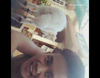 Shirtless guy slaps white dog butt dog comes to camera