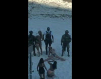 Women bikini split legs in front of solider cops