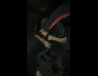Drunk guy sits on ground by car