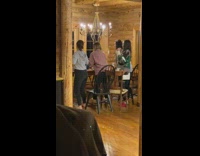 Girls renegade dance at cabin dinner table