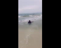 Blue pink bathing suit strong wave fail