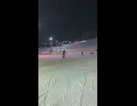 Man Splashes Snow as he Slides Down