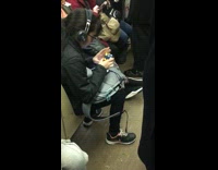 Woman solves a Rubik's cube very fast  on subway train and times herself
