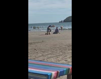 Woman ruffled swimsuit top kneel sit beach