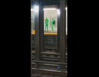 Two guys green bodysuit covers face subway