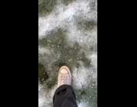 Man steps on snow made satisfying sound