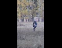 Woman with a jacket and beanie tiktok dance on the fields