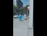 Guy blue plastic inflatable ball around body 