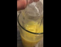 Long ice piece in orange juice cup 