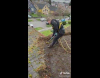 Guy cleans house roof 