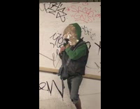 Person with green sweater tape on face