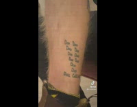 Guy has doo doo beat tattoo on leg 