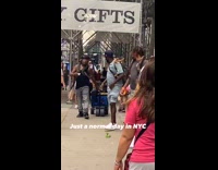 Collab WINY - Four men on sidewalk snakes around them