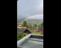 Double rainbow seen near the house window