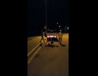 Guy sitting on rug being pulled by truck