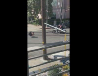 Man in black top on a motorcycle poses in the street