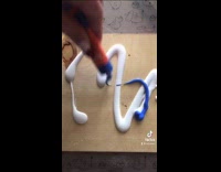 Small brown dog licks bag paints picture 