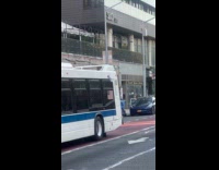 Man begging for money using pole on bus