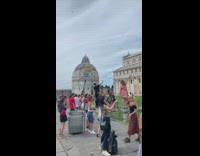 People standing posing leaning tower of pisa