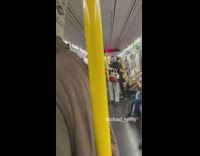 Person on subway wearing purple mask and goggles.