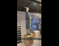 Mannequin wearing blue dress on rotating platform