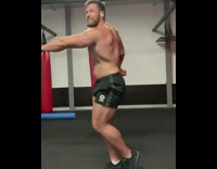 Guy pushes knee back into place gym