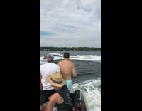Three people blue white boat jump wave 