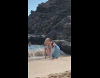 Two girls bikini hold each other beach