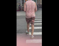 Guy wears shirt and shorts with face on them