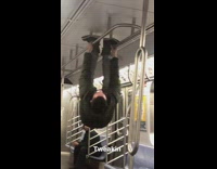 Guy holds onto ceiling rails in empty subway train and walks on roof