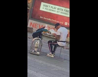 Guy eats alone outside with two birds 