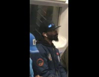 Man wears marquee hat with cuss words on subway train