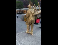 Gold mime cross road talks with man