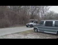 Guy in boat on roof of jeep 