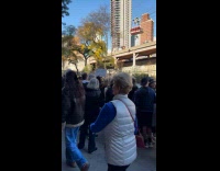 Woman holds board about ex at marathon