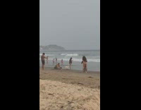 Black wetsuit guy bikini girl dance beach 