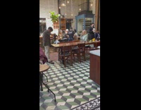 Woman in green checkered polo in a restaurant