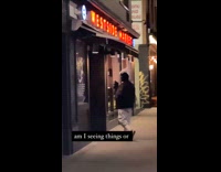 Guy enters market with bird on head 