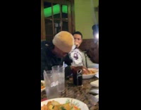 Guy watches water stream in mouth restaurant 