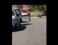 Guy rides stack of skateboards down street