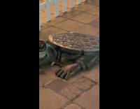 Statue of a crocodile biting a baby
