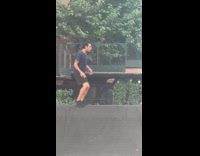 Man holds sex toy crossing on barricade