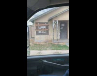 Girls laughing at boarded up airbnb home