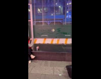 Woman eat snacks on stage beside performer