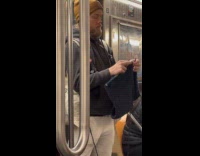 Man stand and knit inside subway train