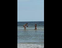 Girl bikini kneel hold hair pose beach